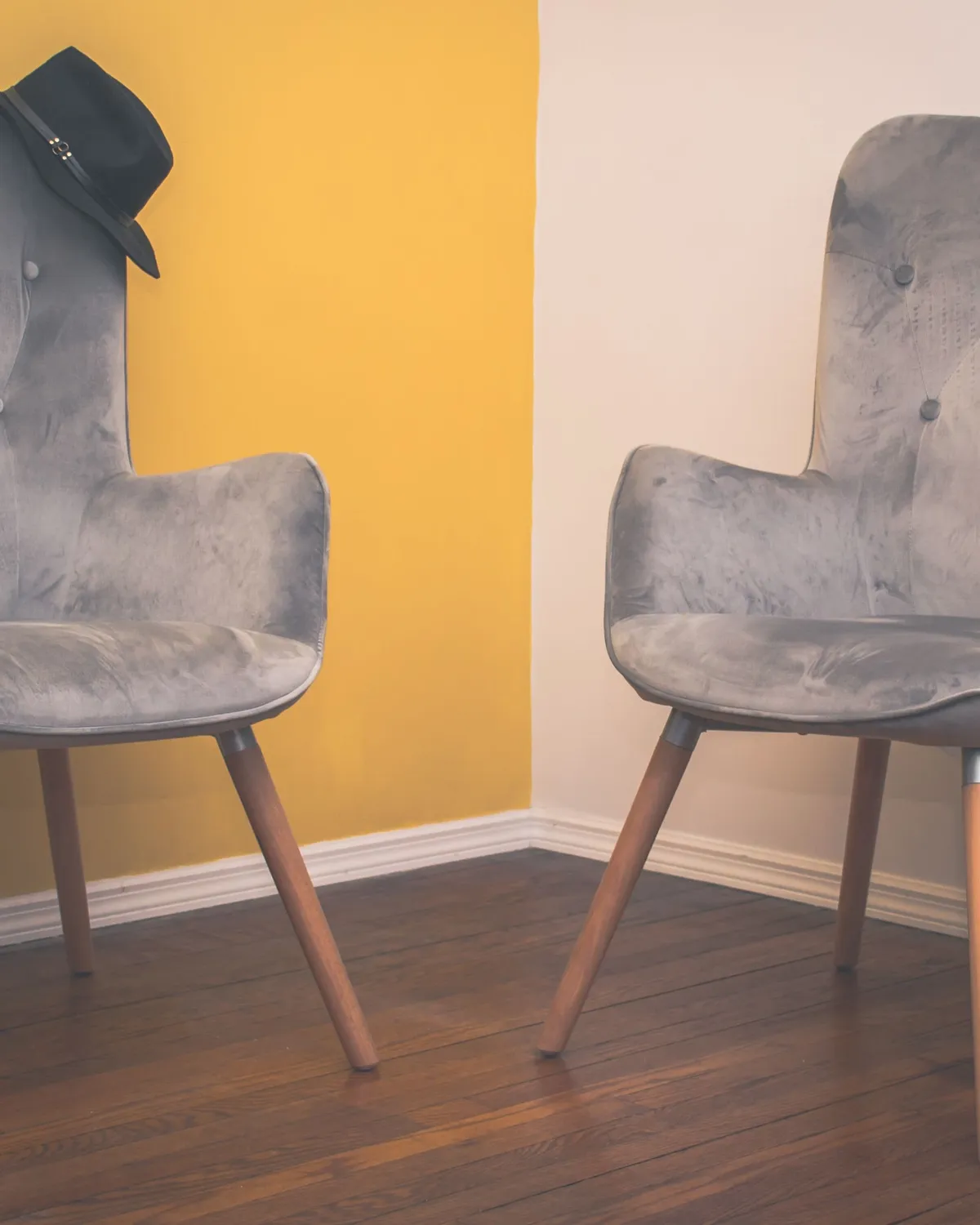 Two empty upholstered wingback chairs facing each other in a room